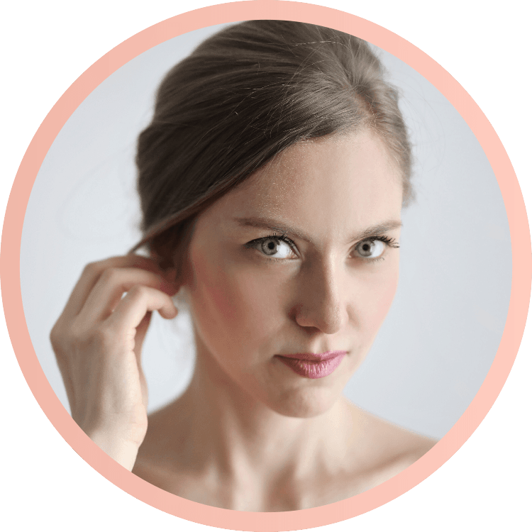 Foto de mujer tocándose la oreja y mirando a la cámara